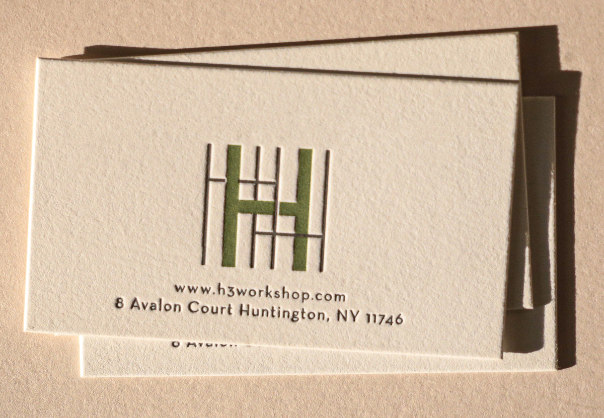 Business card with a logo and text on a beige background