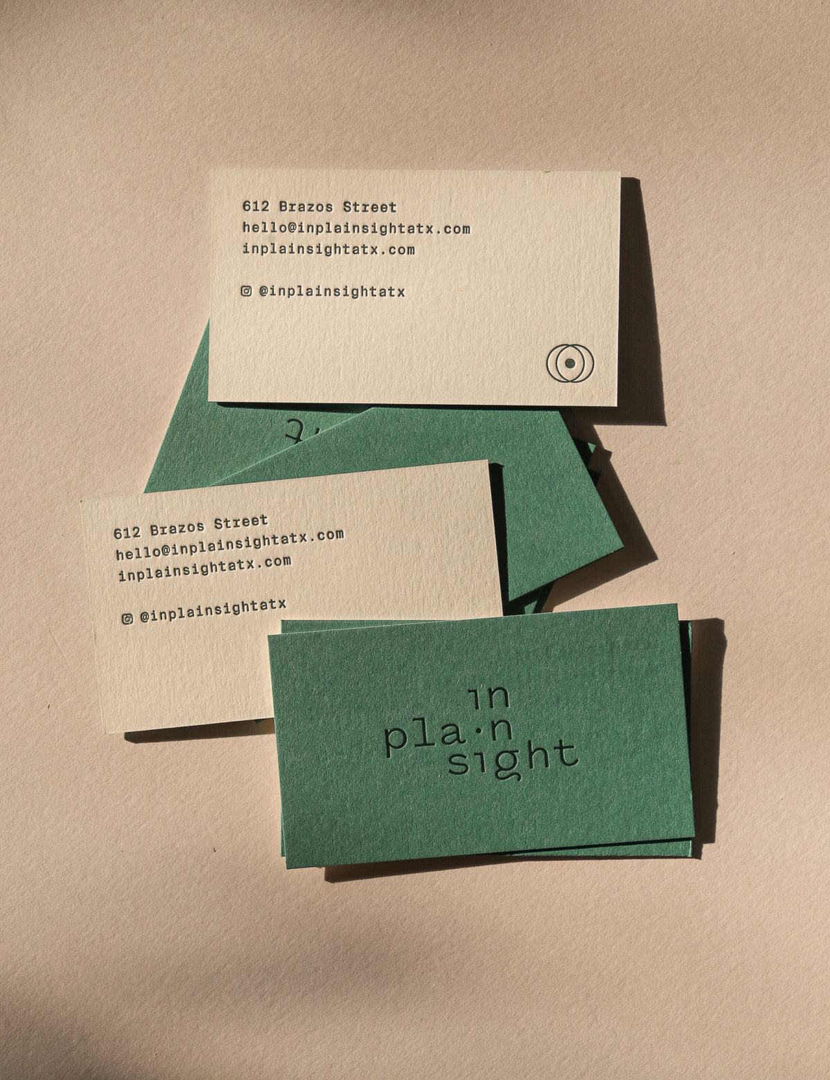 business cards with text and a logo on a beige background