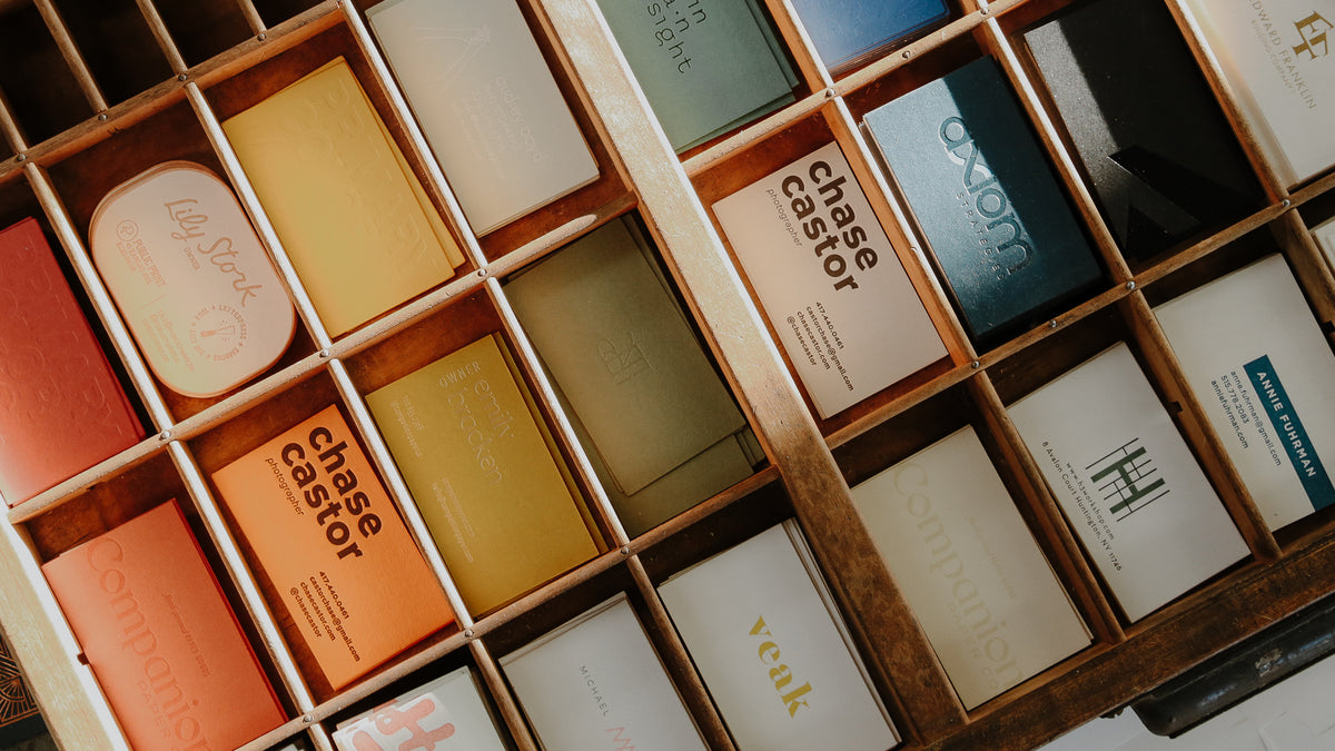 collection of business cards made by public print in a letter press tray. 