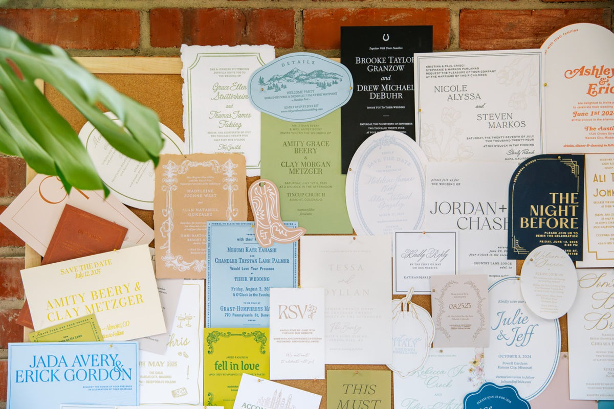 Collection of wedding invitations and stationery items on a brick wall background
Photo by Alyssa Broadus